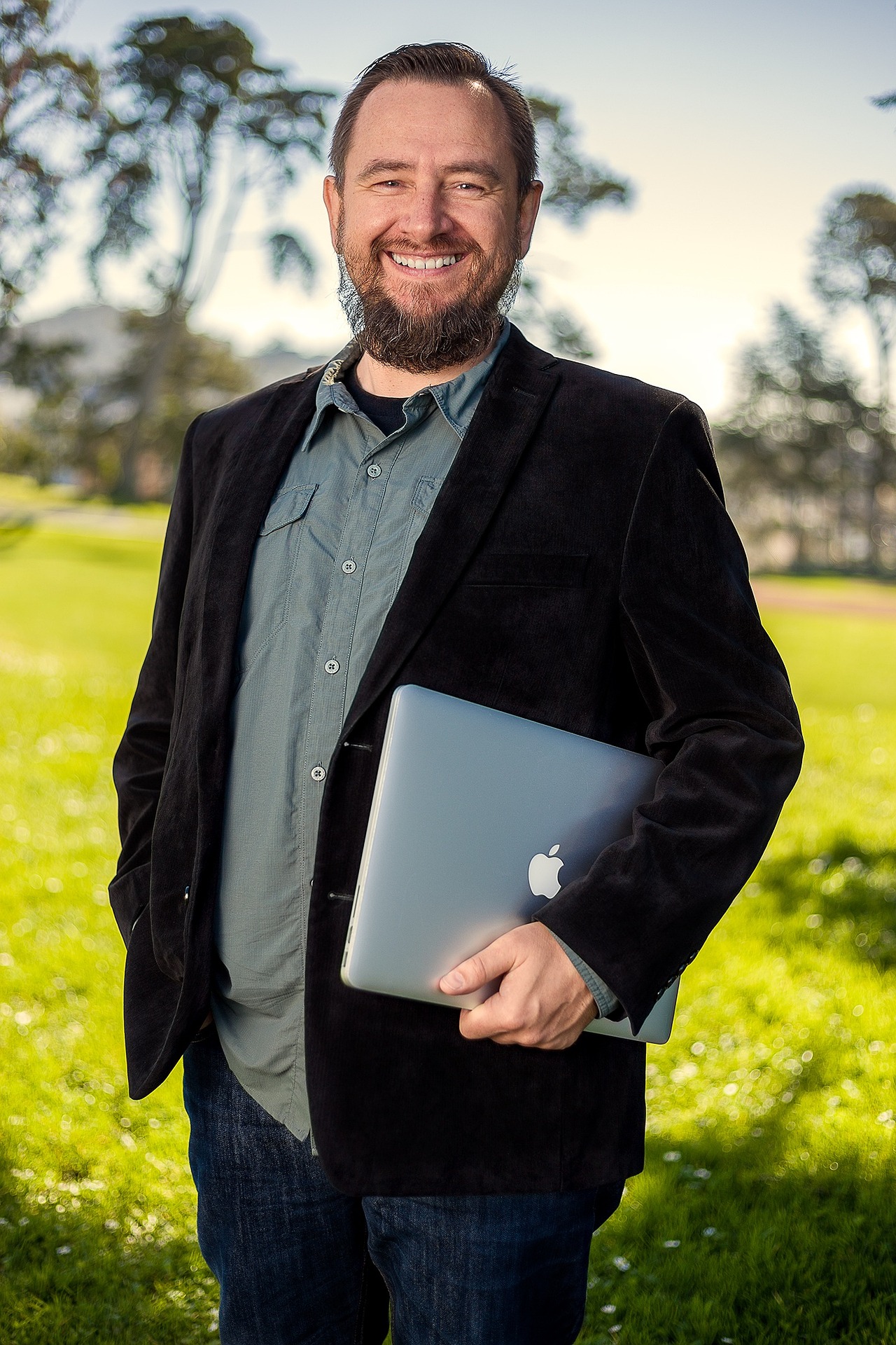 guy in his fifties holding an Apple computer
